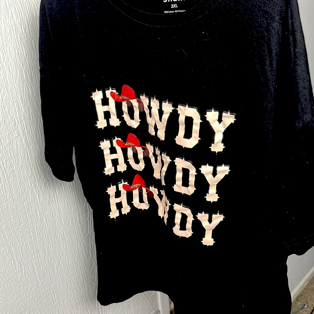 A 2X black T-shirt with the words Howdy on it.
